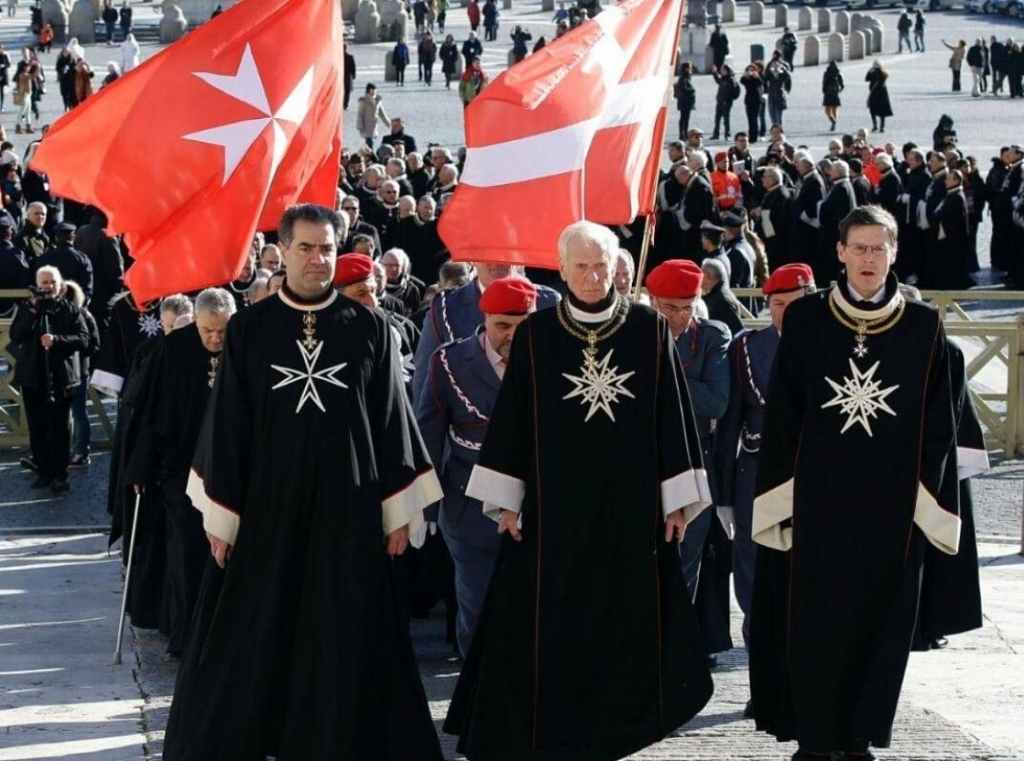 https://maltamalta.com/wp-content/uploads/2020/07/People-walking-in-line-with-the-Maltese-Cross-flag-1024x761.jpg